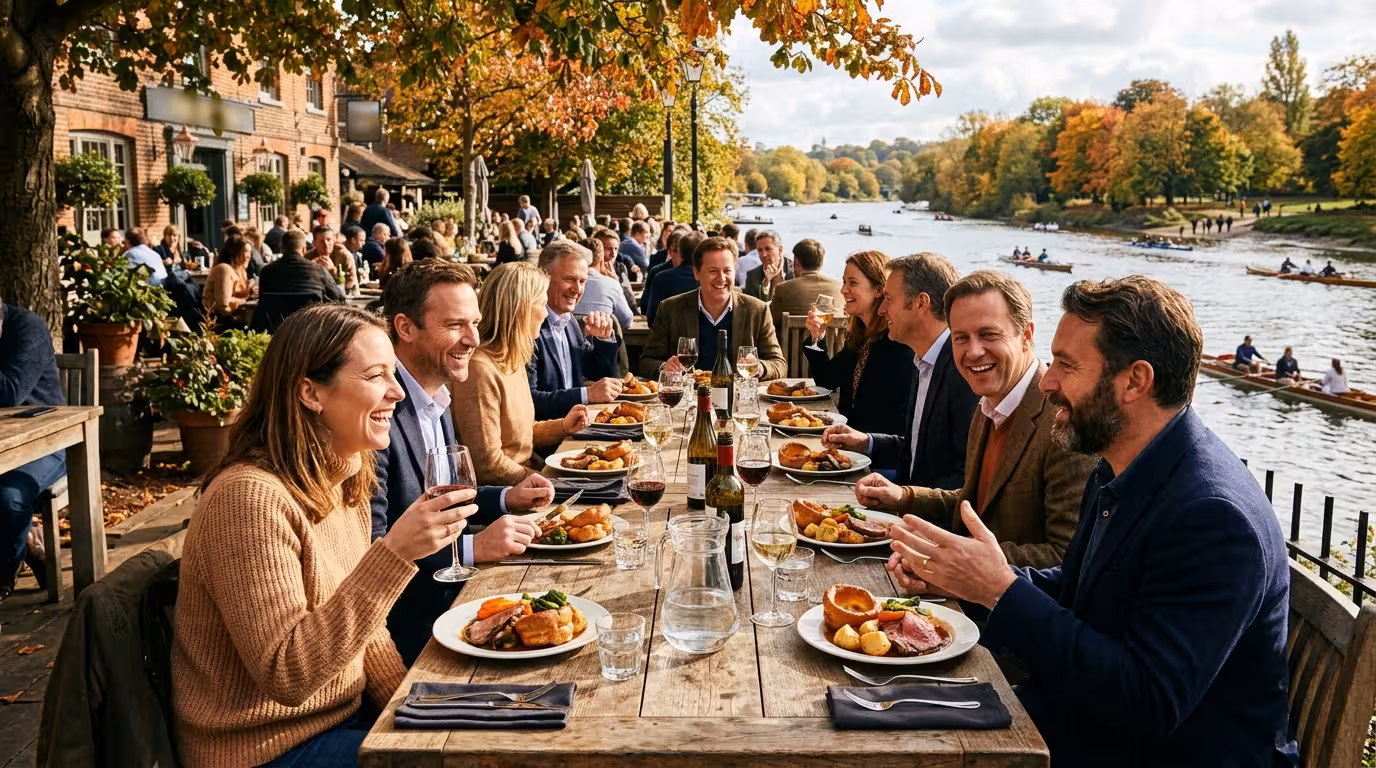Long convivial Sunday pub lunch on a riverside terrace in London with the Thames in the background